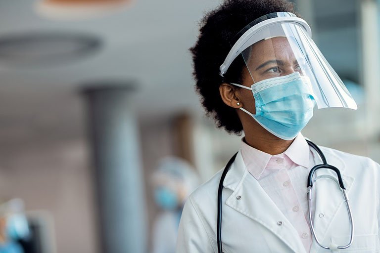 pensive-african-american-female-doctor-with-face-shield-mask-hospital